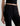 Person wearing black pants on a plain background