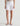 White denim shorts worn by a person on a white background