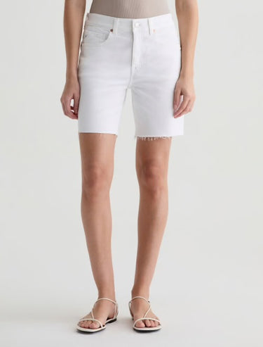 White denim shorts worn by a person on a white background