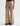 A woman wearing wide leg tan corduroy pants with a relaxed silhouette on a white background