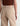 A woman facing backwards wearing wide leg tan corduroy pants with a relaxed silhouette on a white background