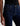 A woman wearing low rise straight dark blue jeans and black heels on a white background.