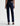 A woman facing backwards wearing low rise straight dark blue jeans and black heels on a white background.