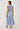 Woman wearing a barletta striped dress on a white background