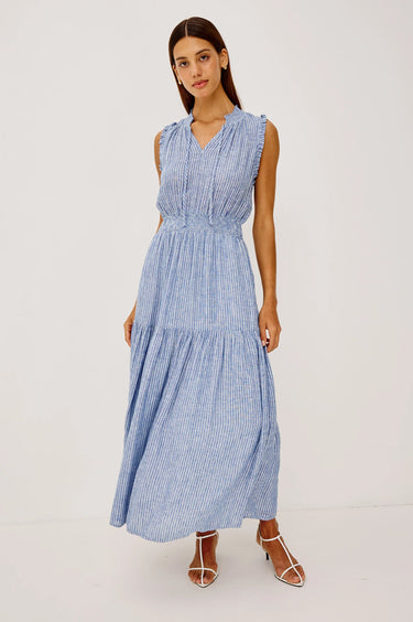 Woman wearing a barletta striped dress on a white background