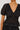 woman wearing black embroidery blouse and skirt on white background