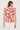 Woman wearing a sleeveless top with red floral pattern on a white background