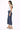 a woman wearing a white tank and dark cropped jeans standing to the side