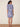 Woman wearing a blue floral dress on a beige background