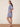 Woman wearing a blue floral dress on a beige background