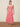 A woman wearing a red and white floral halter midi dress