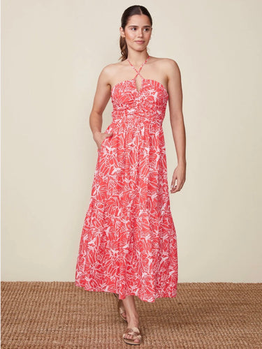 A woman wearing a red and white floral halter midi dress