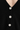 a woman wearing a black cardigan with detailed shiny buttons