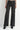 A model wearing black embellished wide leg jeans and black heeled boots on a white background.