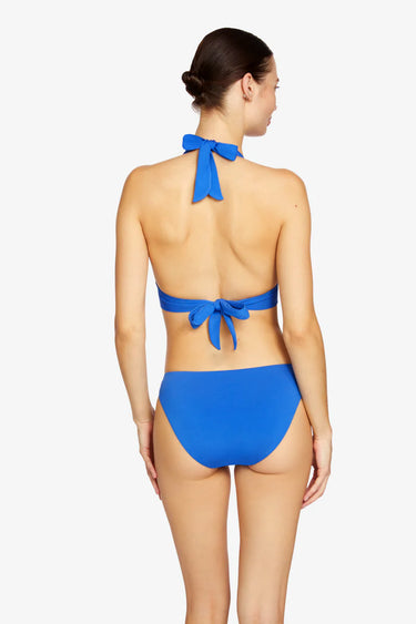 Woman wearing a blue bikini with a white background
