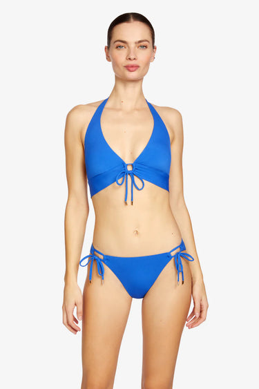 Woman wearing a blue bikini set on a white background