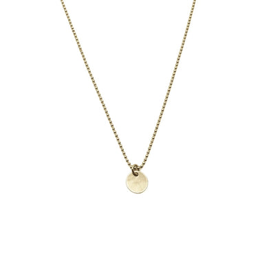 Gold filled dots necklace with a round pendant on a white background