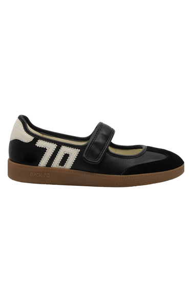 A side view a black Mary Jane sneaker with ‘70’ written in white on the side.