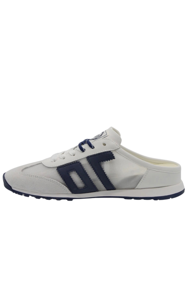 White slip-on shoe with navy accents on a white background