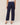 Navy blue pants worn by a person on a beige background
