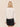 The back view of a white faux leather bomber jacket