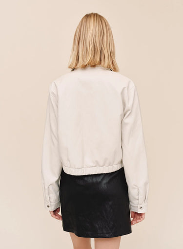 The back view of a white faux leather bomber jacket