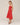 Woman wearing a red dress against a plain background