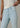 Light blue jeans worn by a person on a neutral background