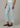 a woman wearing high rise light blue cropped jeans