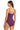 A woman modeling a solid purple one-piece swimsuit from the back, showing the thin shoulder straps and back design, against a plain white background.