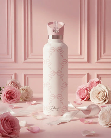 White water bottle with floral design on a pink background with roses