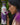 Woman holding a purple water bottle with floral design against a green leafy background