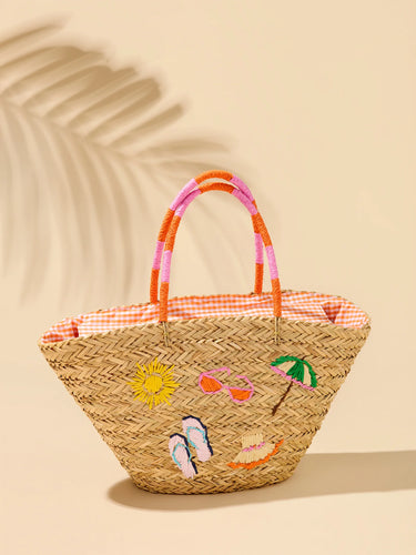 Woven basket with embroidered designs on a beige background