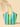 Striped beach bag with green and blue pattern on a beige background