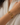 A gold horsebit chain bracelet with a clear square-cut gemstone in the center