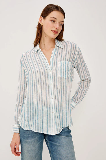 Woman wearing a striped shirt and jeans on a white background