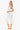 Woman wearing a white crochet dress on a white background