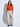Woman wearing a bright orange crewneck sweater layered over a white mock-neck top with relaxed light beige wide-leg pants.