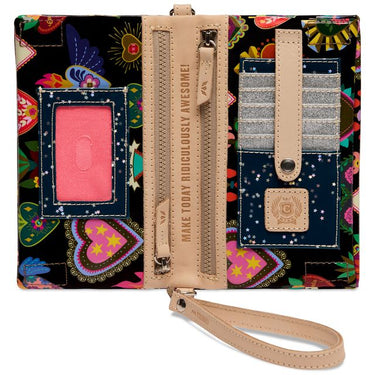 Consuela black crossbody bag inside with ID pocket and 5 pouch card holder with colorful heart and floral print, tan wristlet strap, and striped woven shoulder strap.