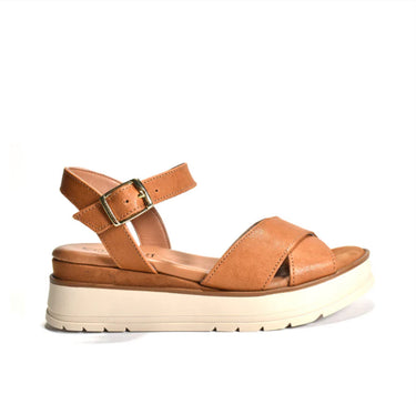 Tan sandal with a white sole on a white background