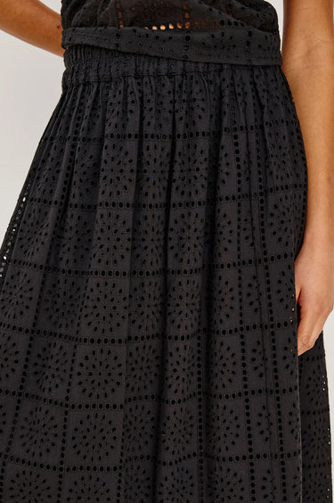 woman wearing black embroidery maxi skirt on white background