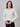 a woman wearing a white sequin cardigan and black leggings on a white background