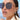 Close-up of a woman wearing sunglasses with a blurred background