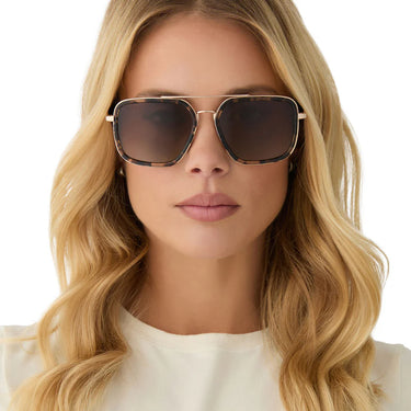 Woman wearing sunglasses with a neutral background