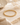 A gold beaded bracelet on a neutral background