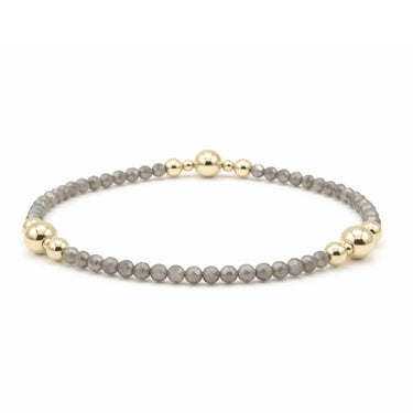 a grey shimmer and gold edges bracelet on a white background