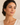 A woman wearing Gold beaded teardrop earrings