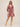 Woman wearing a red floral dress on a white background