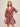 Woman wearing a red floral dress on a beige background