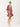 Woman wearing a patterned dress on a white background